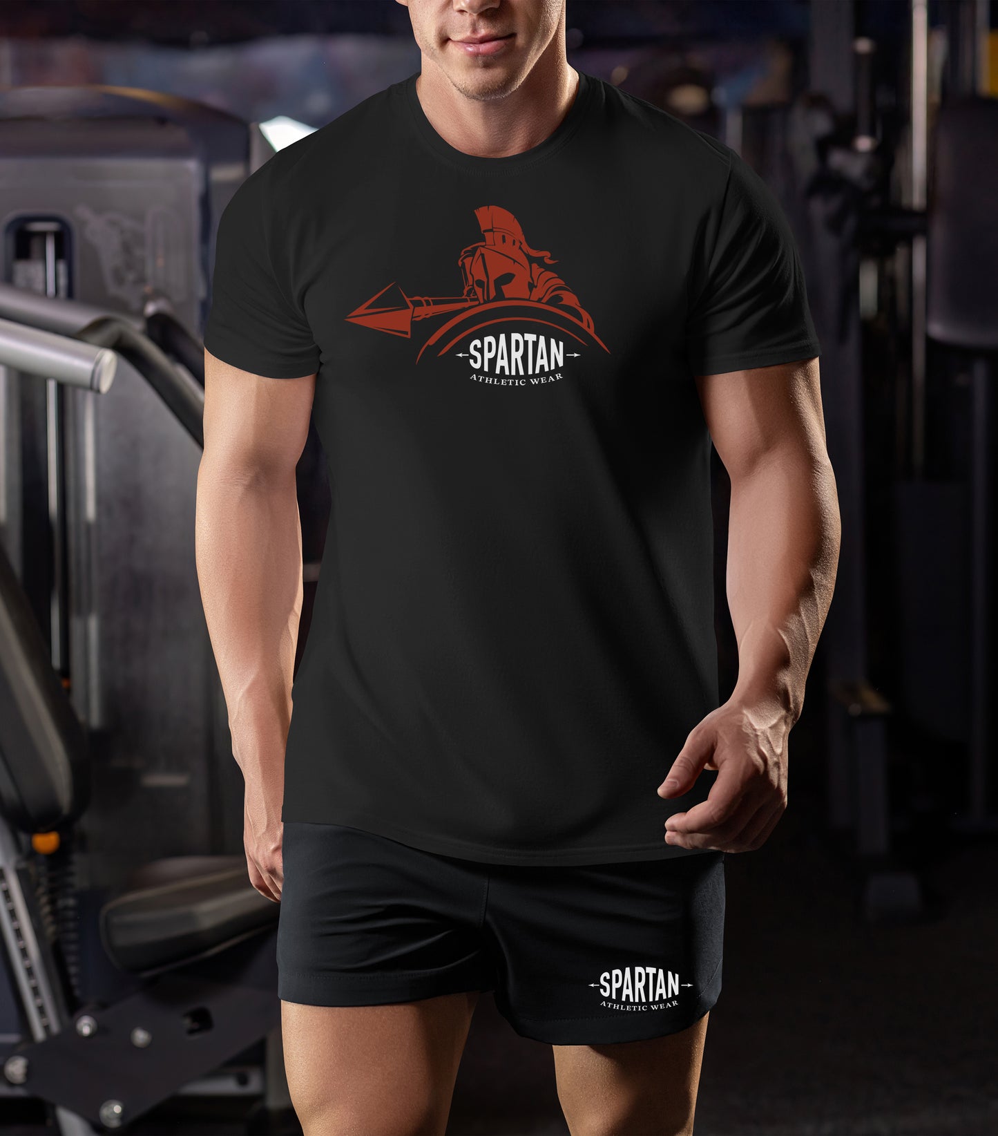 Person wearing a black t-shirt with the Spartan Wear logo in a gym setting