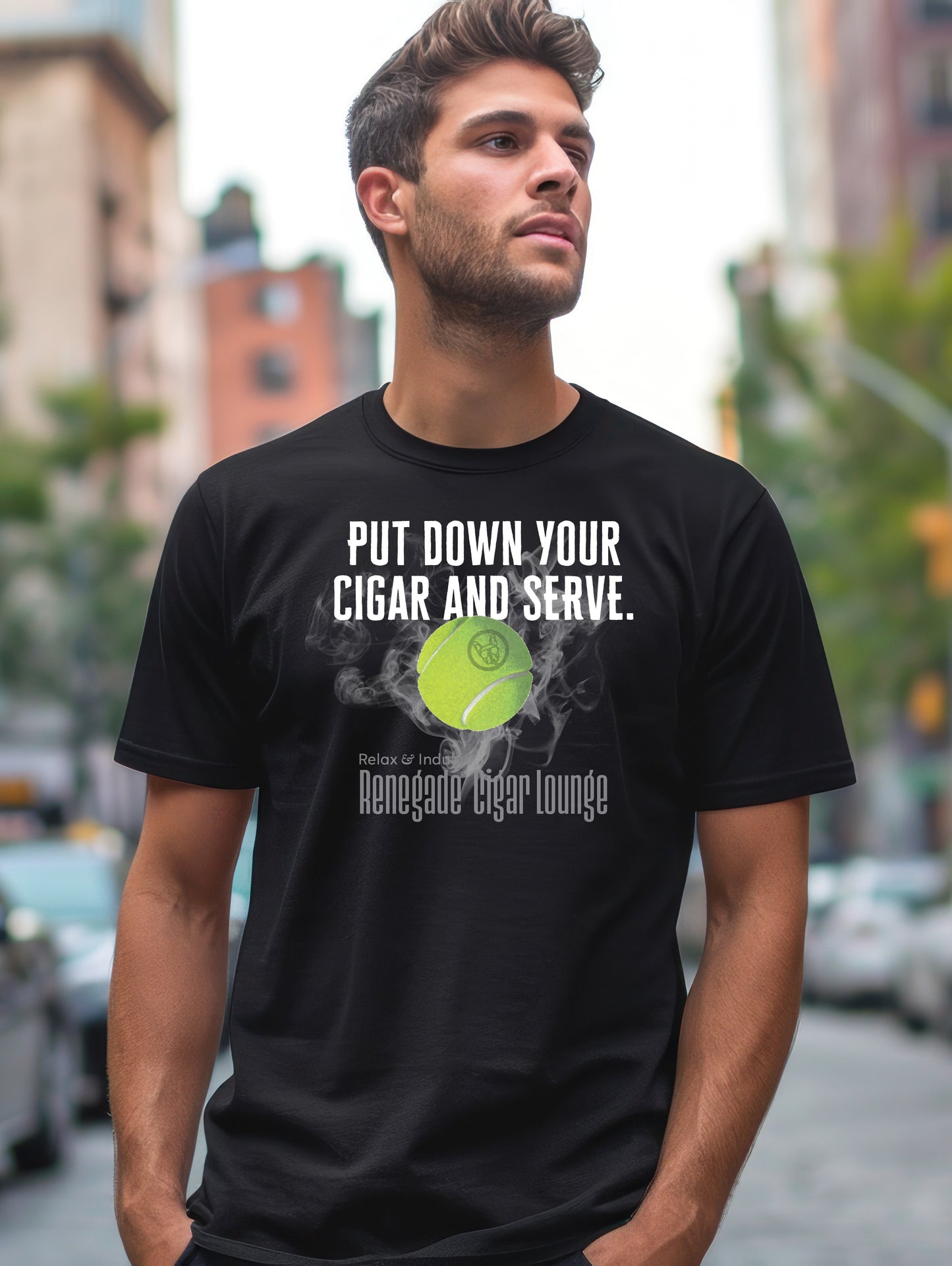 Man wearing a black t-shirt with a tennis ball graphic and text in an urban setting