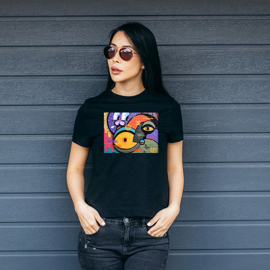 Woman wearing a black t-shirt with a colorful graffiti print.
