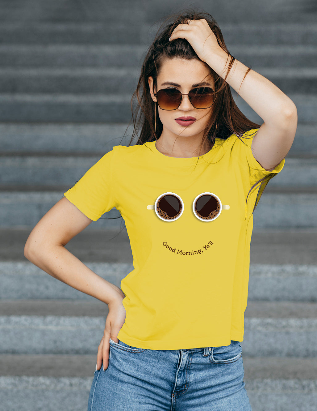 Woman wearing a yellow t-shirt with a graphic design and text