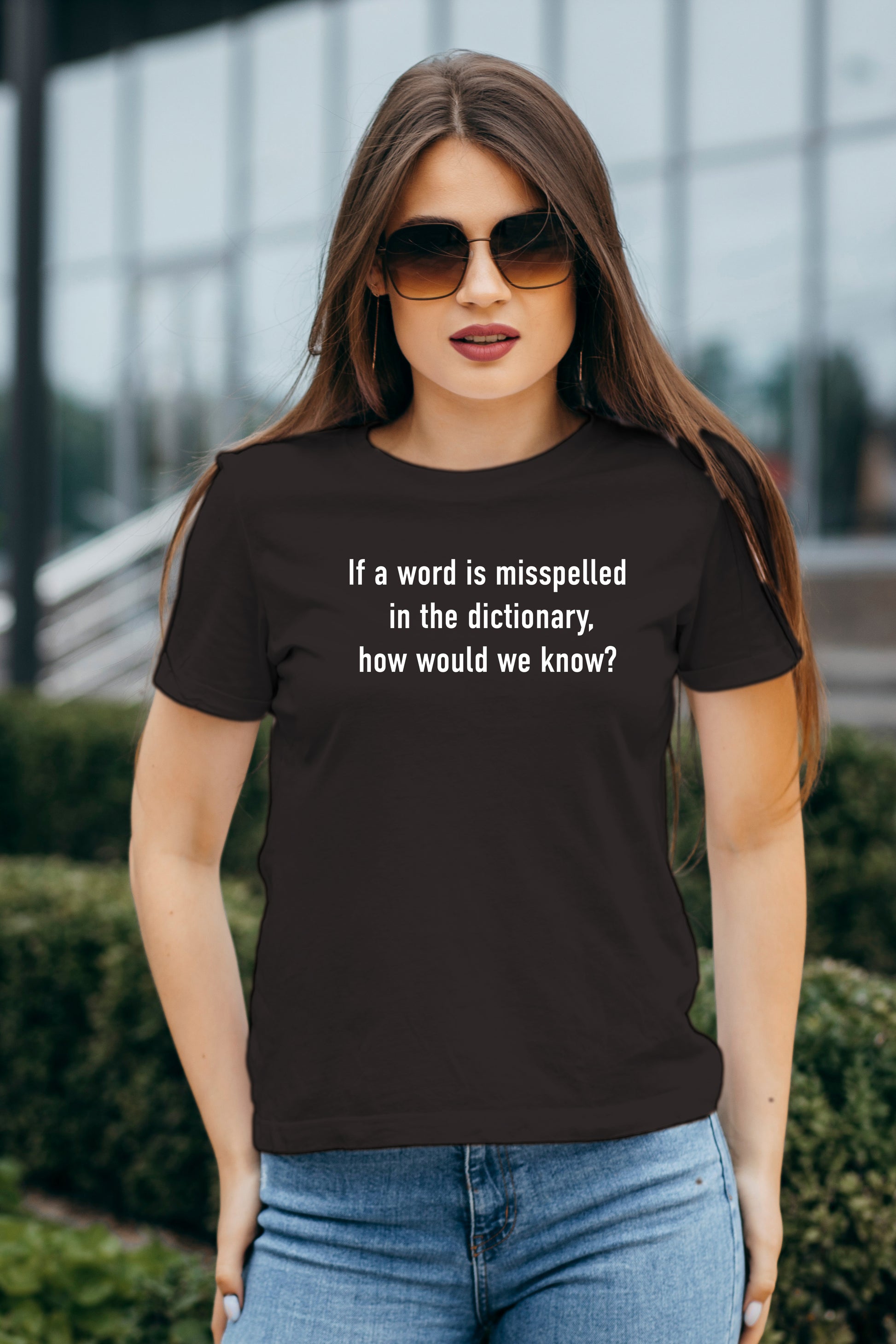 Woman wearing a black t-shirt with text outdoors