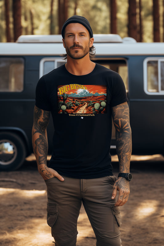Man wearing a black t-shirt with a graphic design of Big Bend National Park in front of a vintage van camping setting