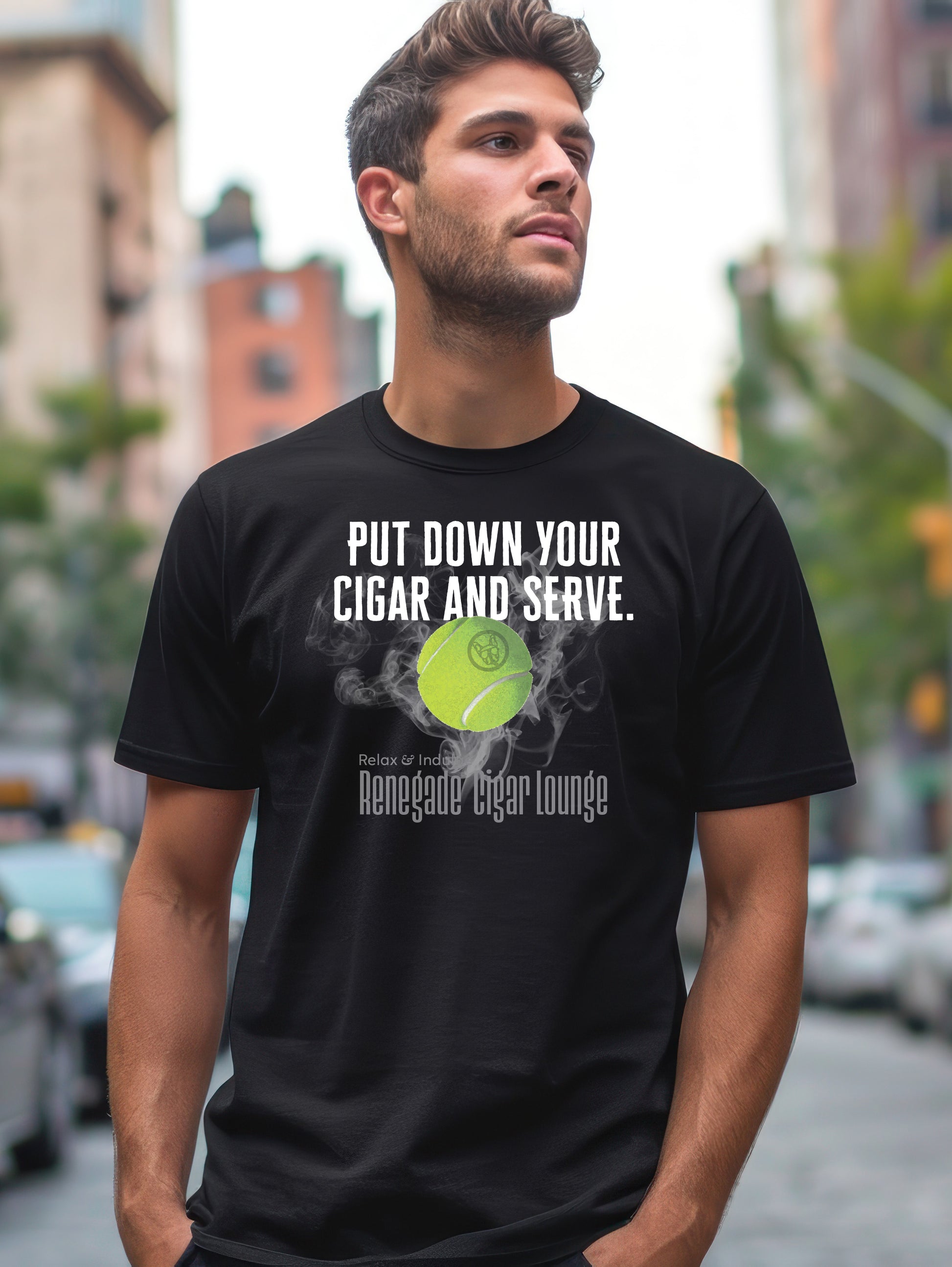 Man wearing a black t-shirt with a tennis ball graphic and text in an urban setting