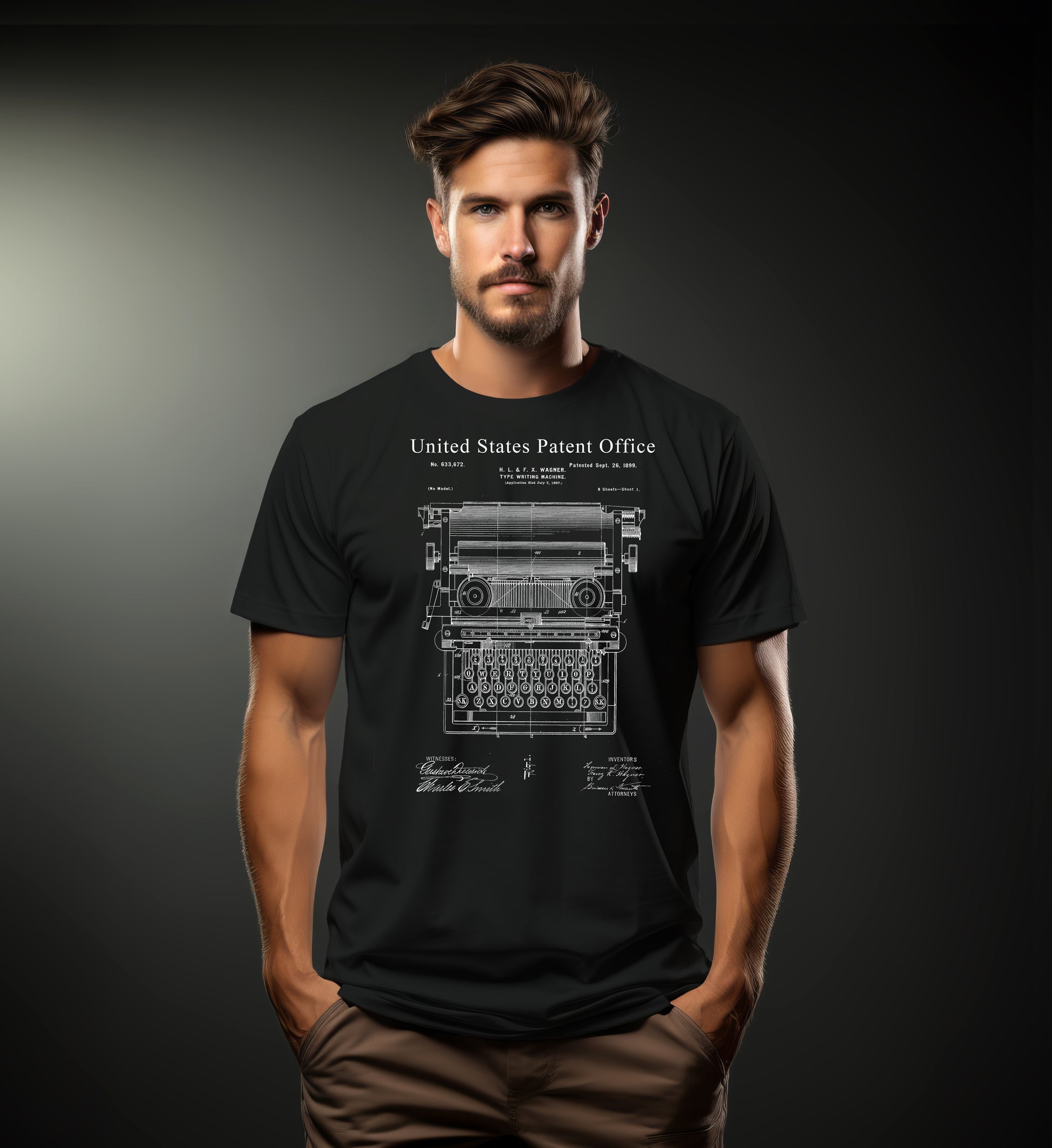 Man wearing a black t-shirt with a typewriter design and 'United States Patent Office' text on a dark background